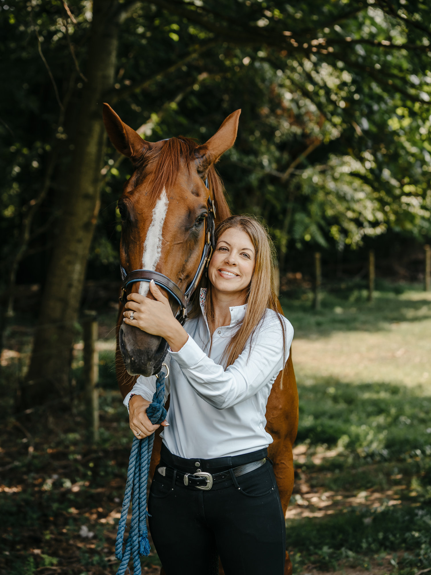 Melisa smiling with her horse. 
